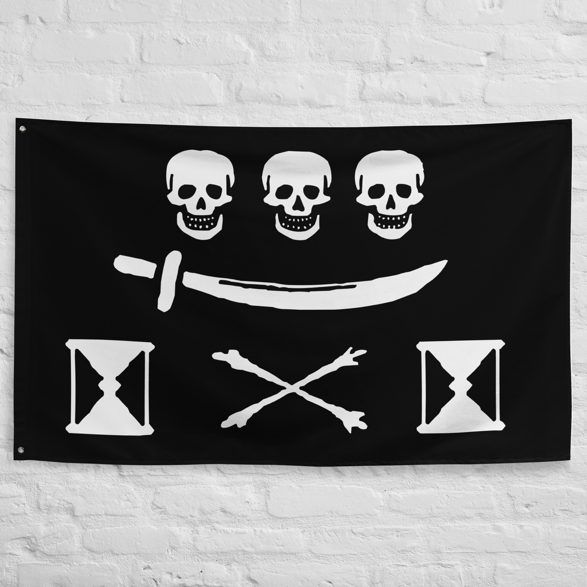 jean-thomas-dulaien-pirate-flag.jpg Jean Thomas Dulaien Pirate Flag featuring three skulls, a cutlass, crossed bones, and hourglasses on a black background symbolizing pirate history and the Golden Age of Piracy.